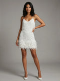 Woman wearing a white fringe hem mini dress in a studio setting