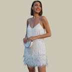 Woman wearing a white fringe hem mini dress - studio photo