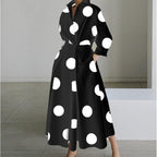 Woman wearing a black polka front wrap collared maxi dress - lifestyle photo
