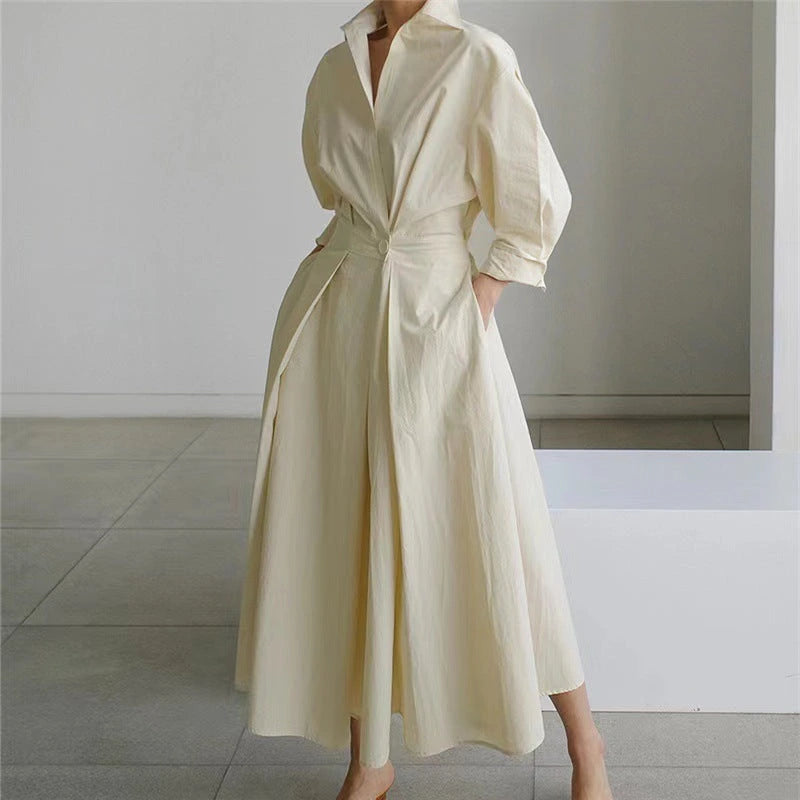 Woman wearing a white front wrap collared maxi dress - studio photo