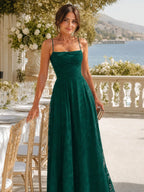 Woman wearing a dark green full lace spaghetti strap maxi dress - editorial style photo