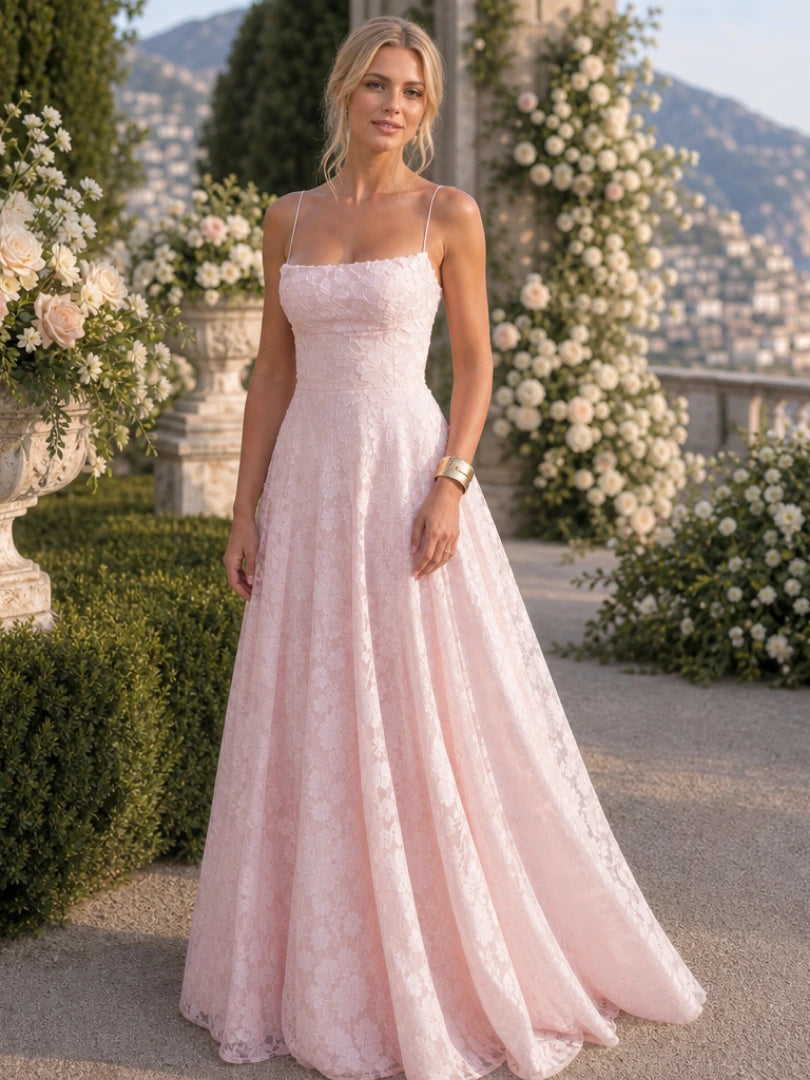 Woman wearing a pink full lace spaghetti strap maxi dress - studio photo