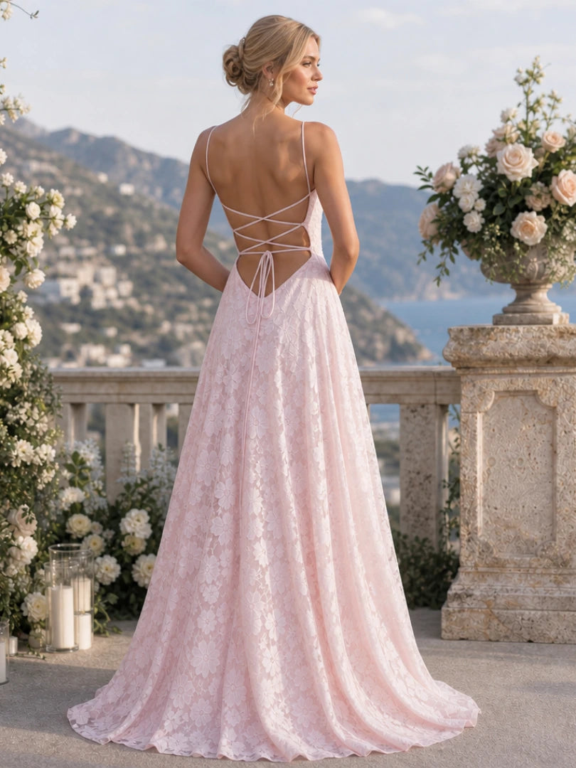 Woman wearing a pink full lace spaghetti strap maxi dress - studio photo