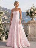 Woman wearing a pink full lace spaghetti strap maxi dress - studio photo