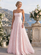 Woman wearing a pink full lace spaghetti strap maxi dress - studio photo