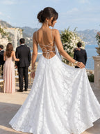 Woman wearing a white full lace spaghetti strap maxi dress - editorial style photo