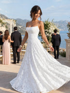 Woman wearing a white full lace spaghetti strap maxi dress - editorial style photo