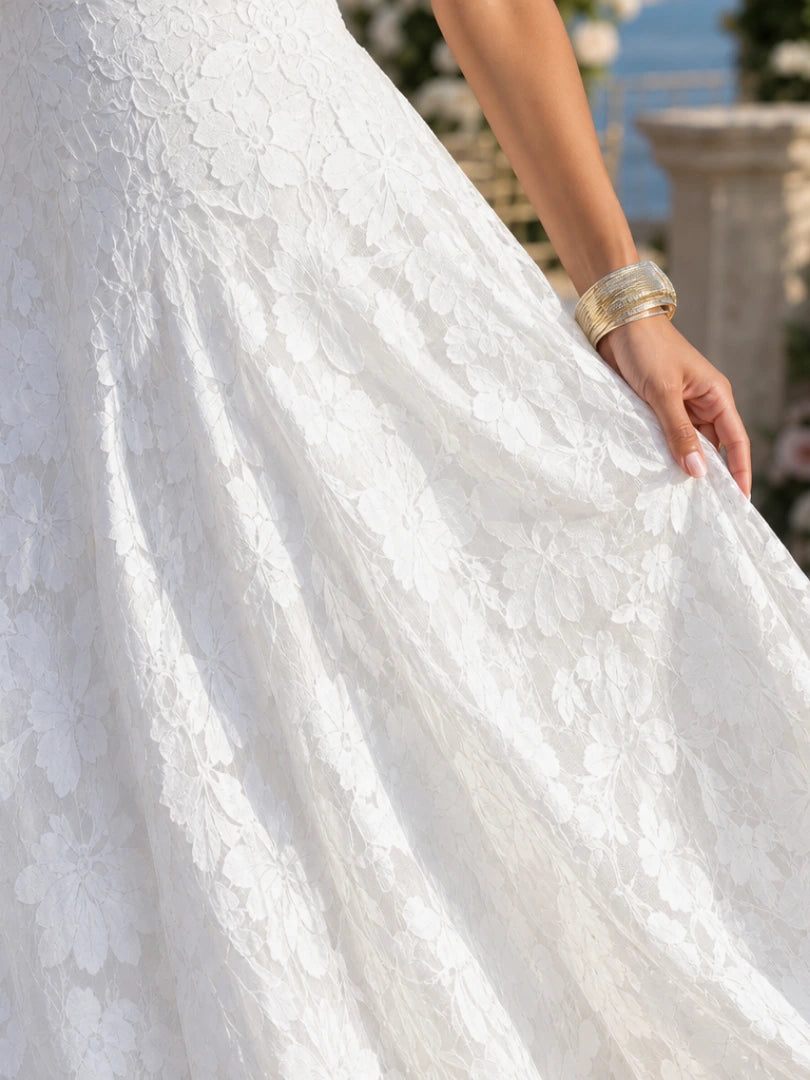 Woman wearing a white full lace spaghetti strap maxi dress - studio photo
