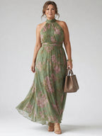 Woman wearing a sage green gathered halter midi dress - editorial style photo