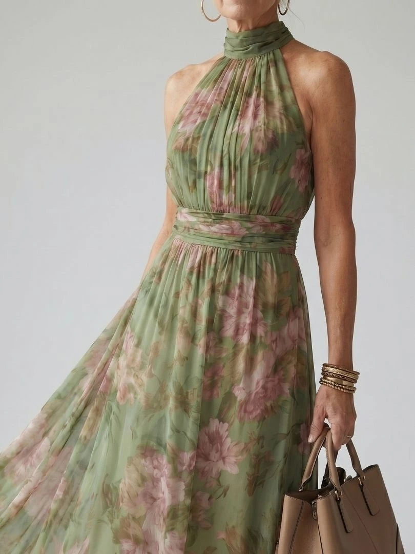 Woman wearing a sage green gathered halter midi dress - studio photo