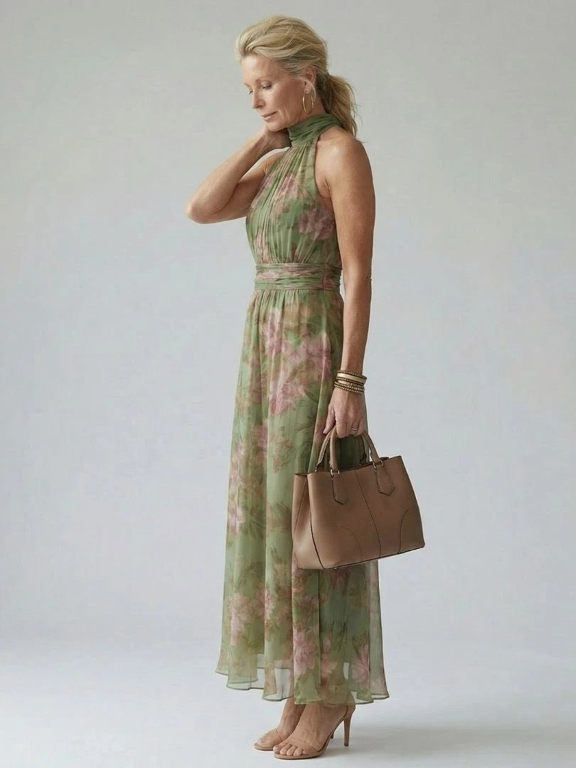 Woman wearing a sage green gathered halter midi dress - studio photo