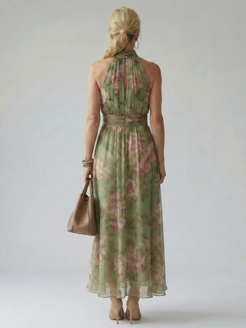 Woman wearing a sage green gathered halter midi dress - studio photo