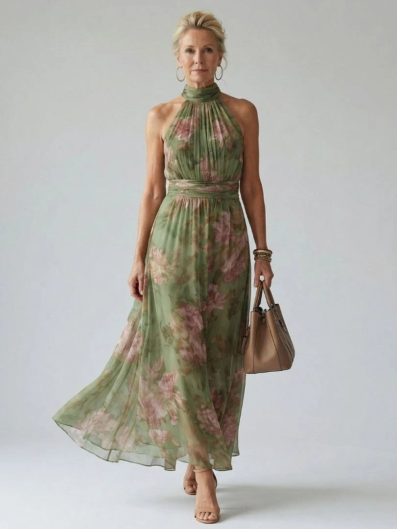 Woman wearing a sage green gathered halter midi dress - studio photo