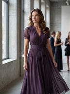 Woman wearing a purple gathered-waist keyhole maxi dress - editorial style photo