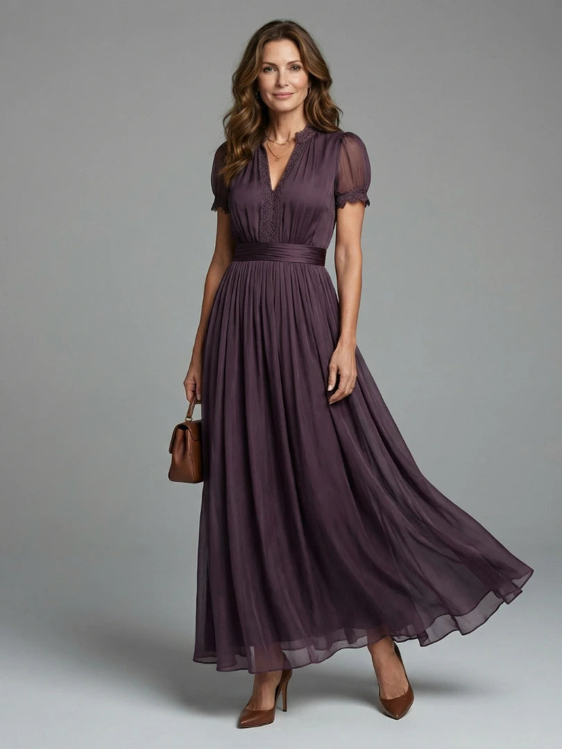 Woman wearing a purple gathered-waist keyhole maxi dress - studio photo