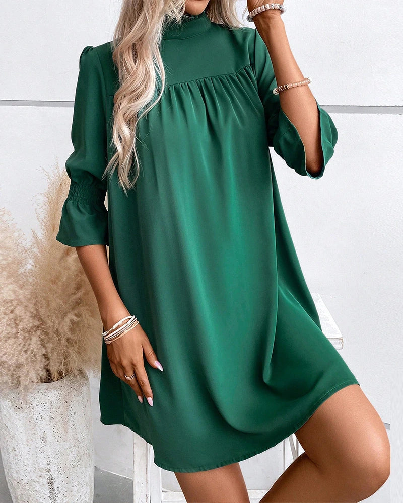 Driftly green high neck mini dress with ruffle sleeves, angled view