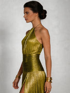 Woman wearing a green halter neck pleated high slit maxi dress - editorial style photo