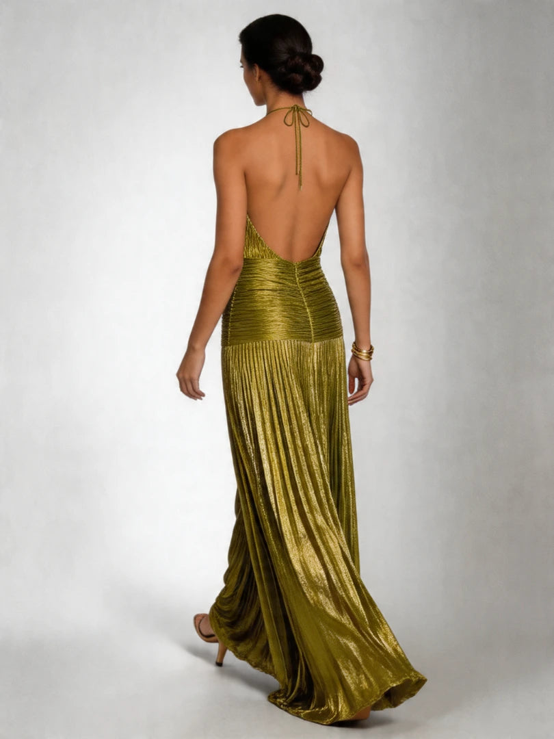 Woman wearing a green halter neck pleated high slit maxi dress - studio photo