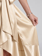 Woman wearing a beige halter wrap asymmetric midi dress - studio photo