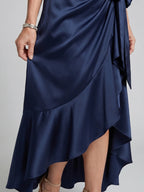 Woman wearing a red halter wrap asymmetric midi dress - editorial style photo