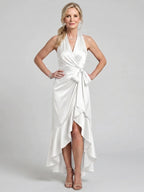 Woman wearing a white halter wrap asymmetric midi dress - editorial style photo