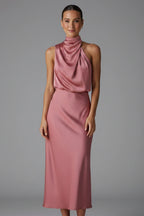 Woman wearing a baked rose high neck draped front dress - studio photo