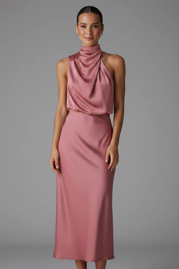 Woman wearing a baked rose high neck draped front dress - studio photo