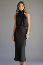 Woman wearing a black high neck draped front dress - studio photo