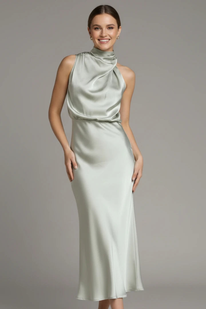 Woman wearing a champagne high neck draped front dress - studio photo