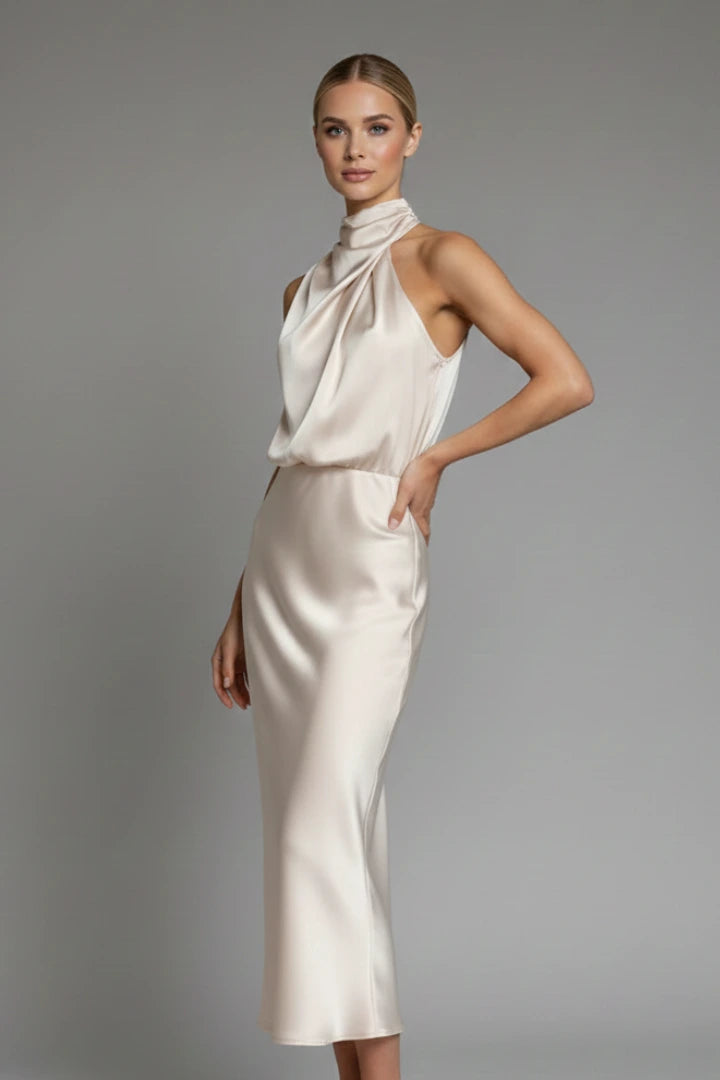 Woman wearing a champagne high neck draped front dress - studio photo