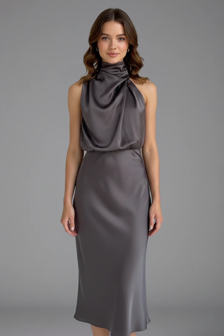 Woman wearing a grey high neck draped front dress - studio photo