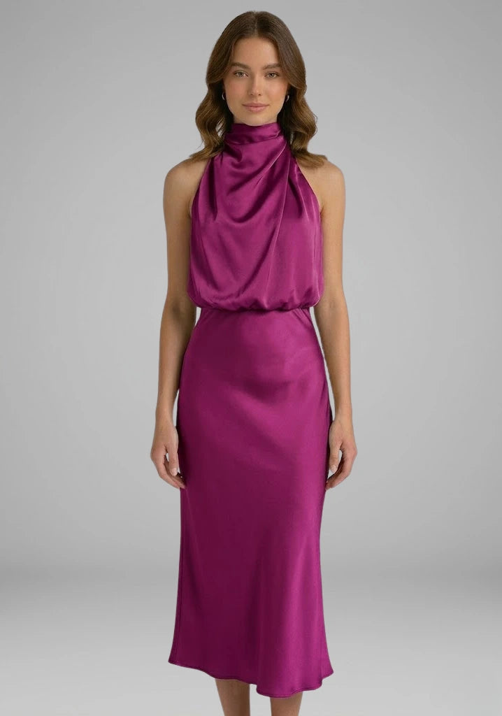 Woman wearing a plum high neck draped front dress - studio photo
