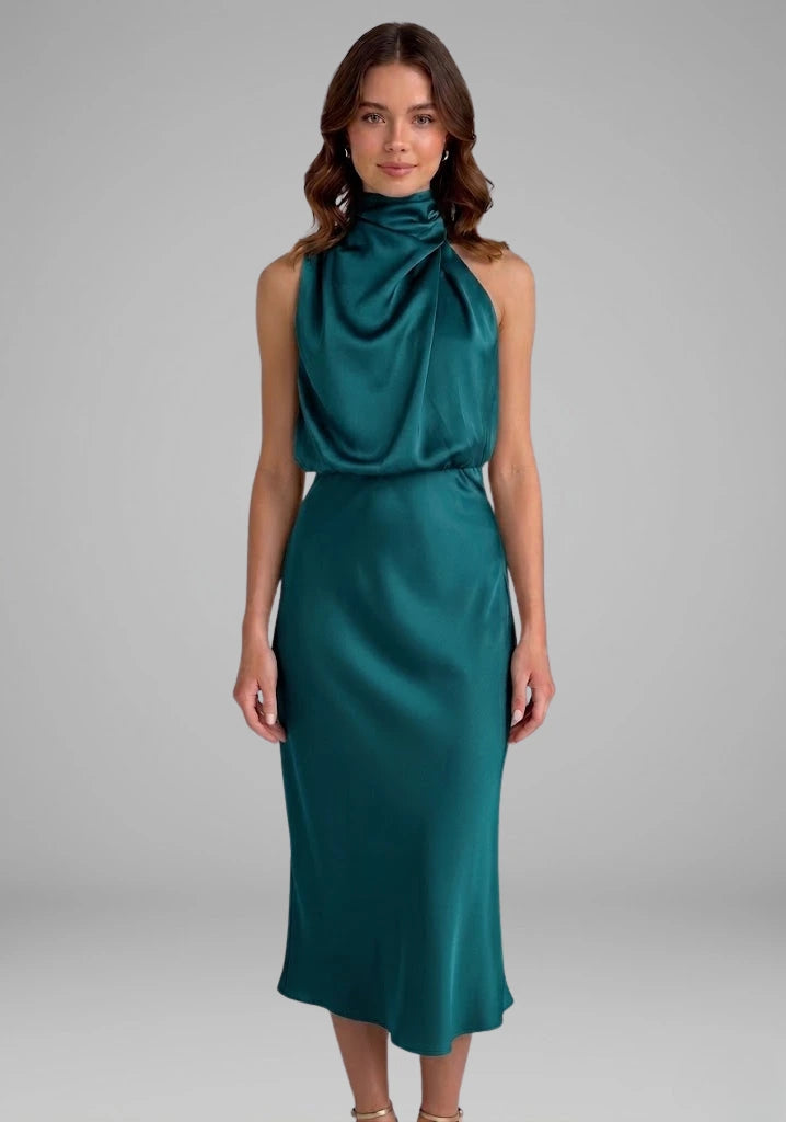 Woman wearing a turquoise high neck draped front dress - studio photo