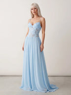 Woman wearing a light blue lace bustier maxi dress in a studio setting