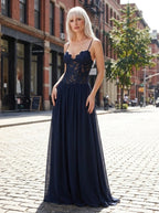 Woman wearing a navy blue lace bustier maxi dress on a city street