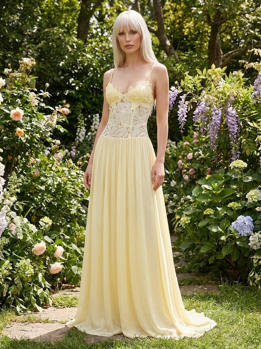 Woman wearing a yellow lace bustier maxi dress in a garden