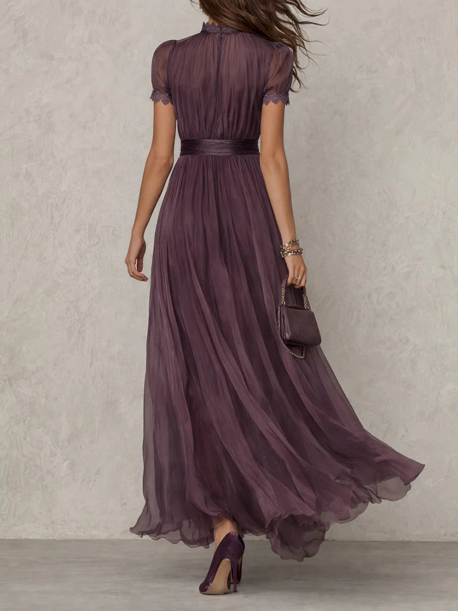 Woman wearing a purple lace trim gathered waist maxi dress - studio photo
