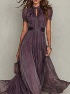 Woman wearing a purple lace trim gathered waist maxi dress - studio photo