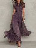 Woman wearing a purple lace trim gathered waist maxi dress - studio photo