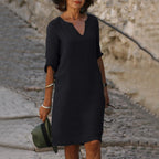 Woman wearing a black lightweight summer everyday dress - editorial style photo