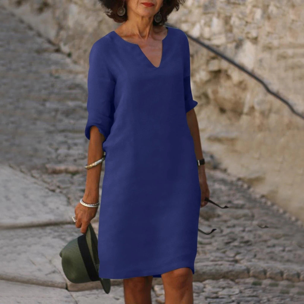 Woman wearing a dark blue lightweight summer everyday dress - editorial style photo