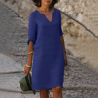 Woman wearing a dark blue lightweight summer everyday dress - editorial style photo