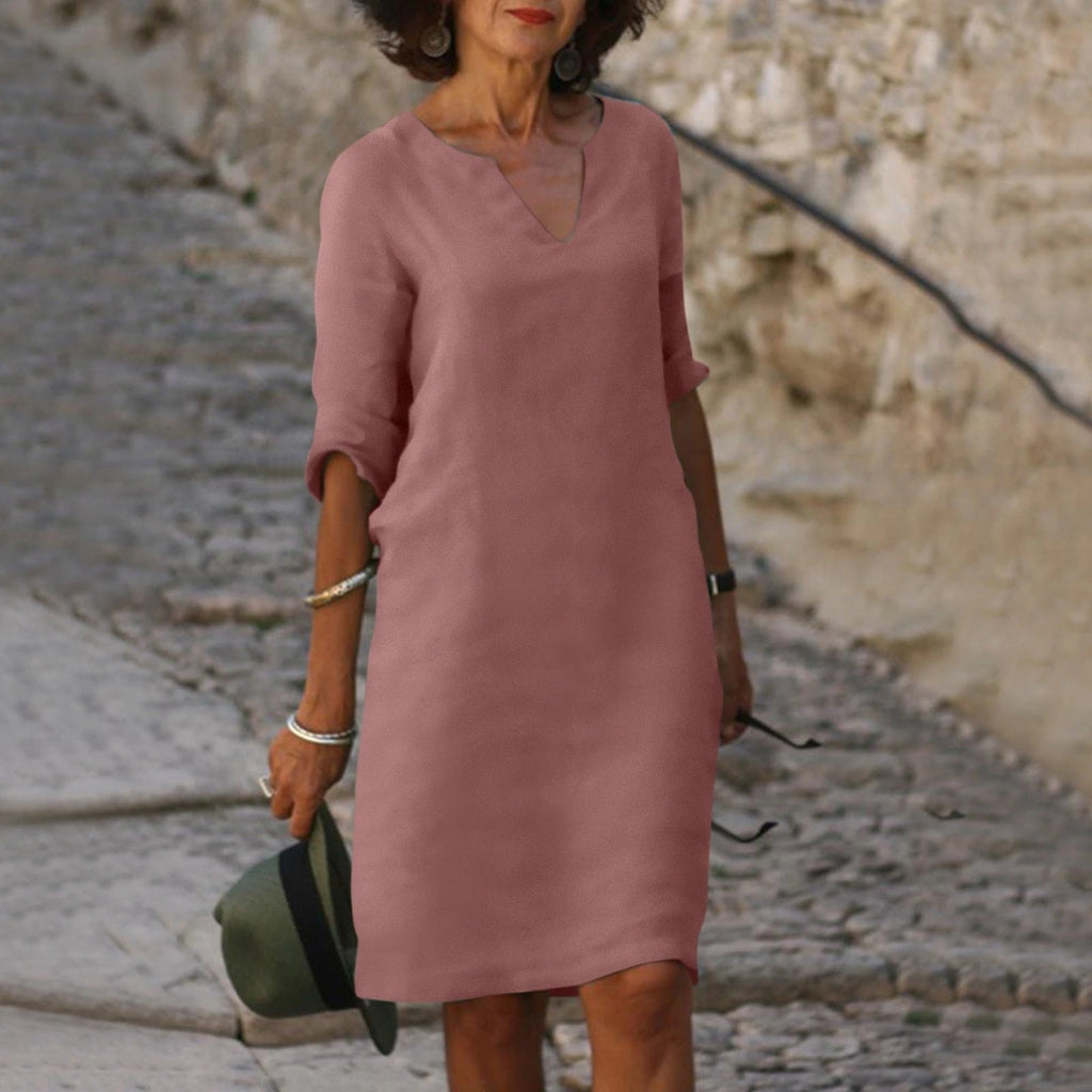 Woman wearing a dark pink lightweight summer everyday dress - editorial style photo