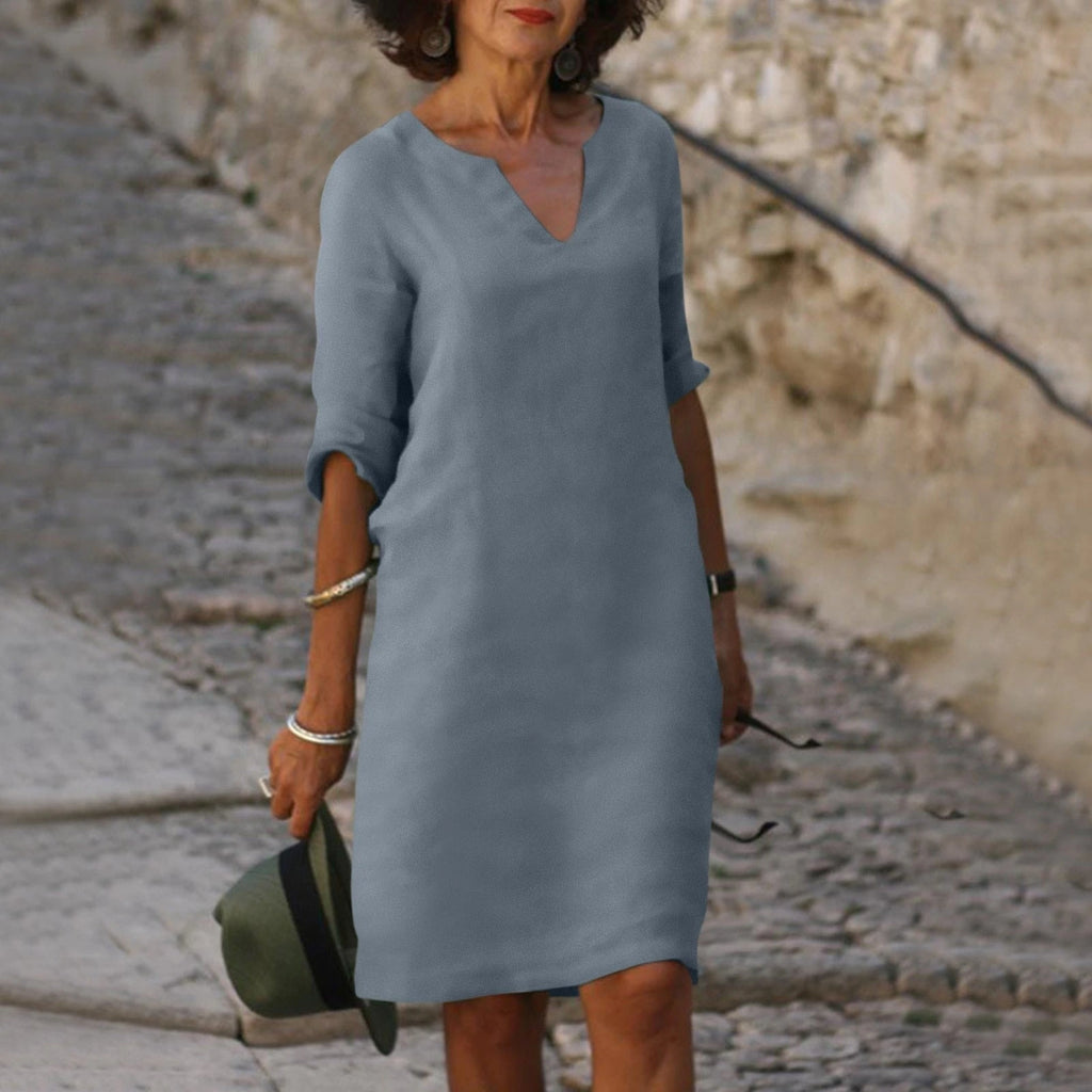 Woman wearing a grey lightweight summer everyday dress - editorial style photo