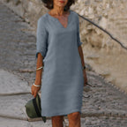 Woman wearing a grey lightweight summer everyday dress - editorial style photo