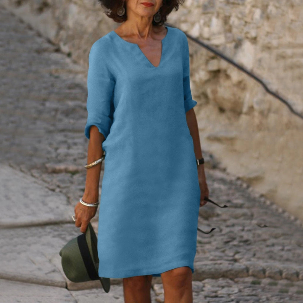 Woman wearing a light blue lightweight summer everyday dress - editorial style photo