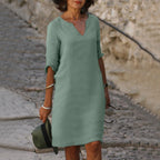 Woman wearing a light green lightweight summer everyday dress - editorial style photo
