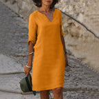 Woman wearing a orange lightweight summer everyday dress - editorial style photo