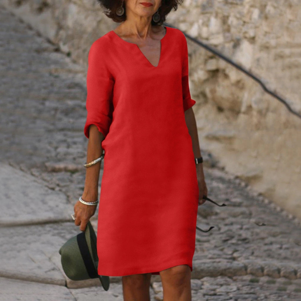 Woman wearing a red lightweight summer everyday dress - editorial style photo