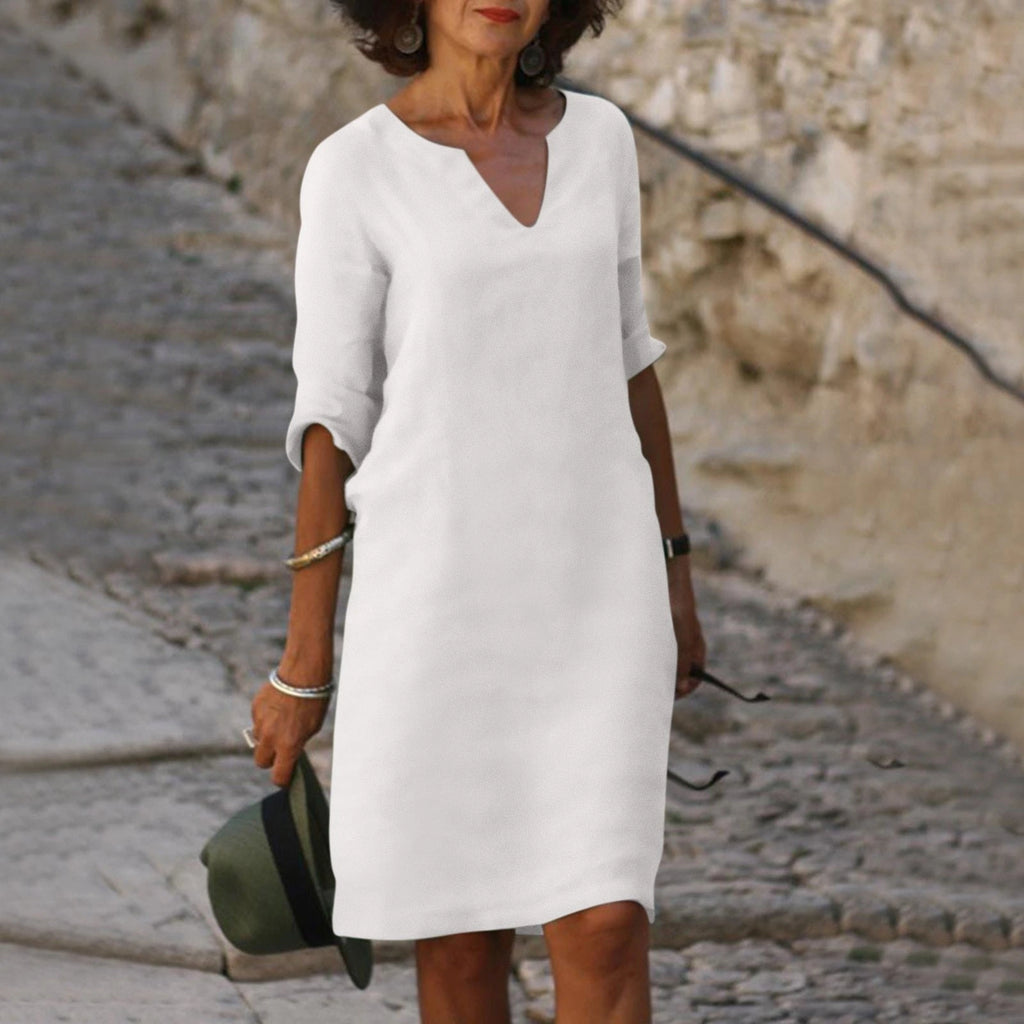 Woman wearing a white lightweight summer everyday dress - editorial style photo